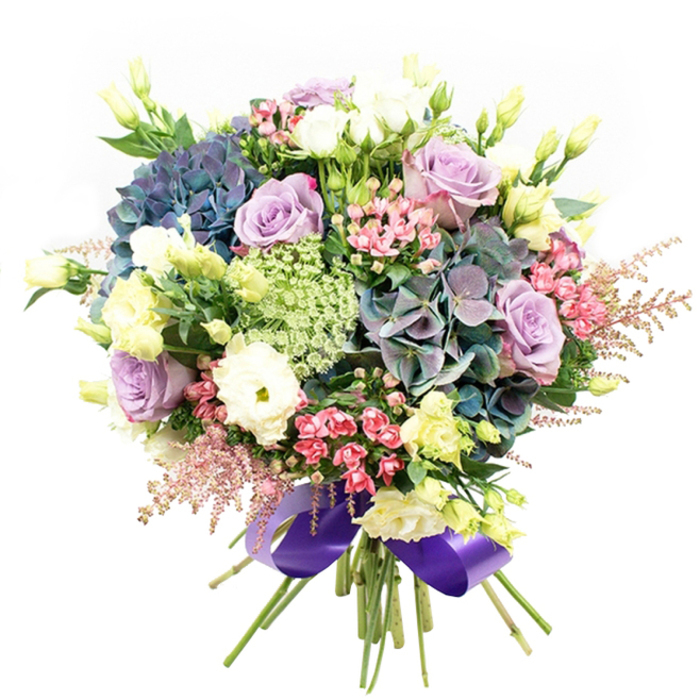 This stunning bouquet, flourishing in the heart of Ealing, unfolds a vibrant collage of cool purples, serene blues, classic whites, and soft greens-each element thoughtfully arranged to tell its own floral story. Central blooms of indigo and teal hydrangeas anchor the composition, their lush clusters reminiscent of the abundant plantings seen in Lammas Park. Nestled among them, lavender and creamy white roses gently open, exuding a timeless charm and light fragrance. White ranunculus, with their densely swirled petals, add gentle softness, while elegant lisianthus buds in subtle yellows and greens punctuate the bouquet with delicate brightness and height. Scattered throughout, sprays of vivid fuchsia waxflowers and feathery blush-pink astilbe sway at the edges, offering a whimsical, airy grace that recalls Ealing's peaceful garden squares. Pale lacy Queen Anne's lace or Ammi Majus brings intricate texture and a captivating sense of freshness, while glossy dark green leaves form a lush supporting base. The bouquet's stems are tightly gathered, finished with a wide, lustrous purple satin ribbon-an elegant nod to the refined palette and the local florist's craftsmanship. Perfect as a heartfelt gift or an exquisite centrepiece, this arrangement reflects the celebratory spirit and welcoming atmosphere of Ealing, promising delight for any special moment.